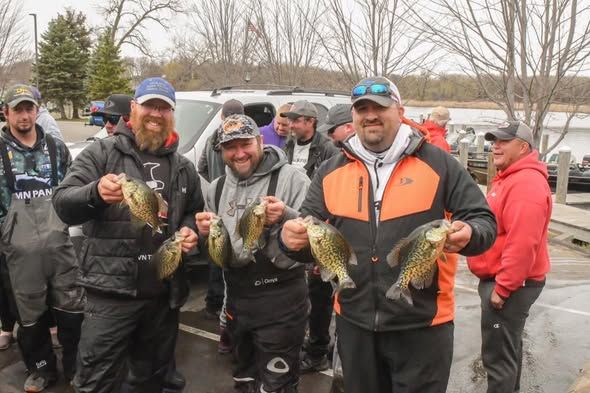 Anglers holding up crappies at a tournament weigh-in